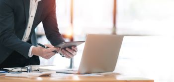 businessman-in-suit-is-working-on-digital-tablet-o-2024-12-06-11-44-18-utc350 businessman-in-suit-is-working-on-digital-tablet-o-2024-12-06-11-44-18-utc350