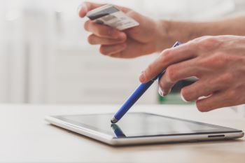 man-using-pc-tablet-with-stylus-and-credit-card-at-2025-02-14-20-37-13-utc350